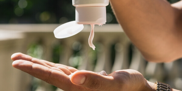 A person applying some sunscreen.