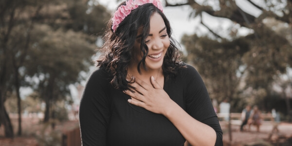A woman laughing outside.