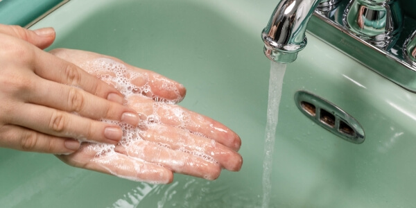A person washing their hands.