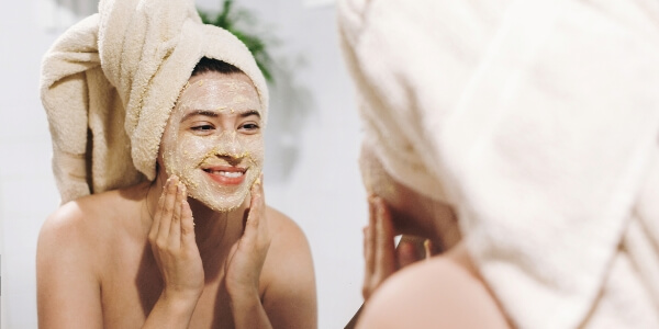 A woman washing her face.